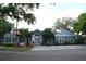 Community clubhouse with an American flag, dedicated parking, and landscaped front yard at 2593 Grassy Point Dr # 101, Lake Mary, FL 32746