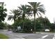 Community entrance with palm trees and signage at 2593 Grassy Point Dr # 101, Lake Mary, FL 32746