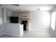 Eat-in kitchen featuring neutral walls, cabinets, black appliances, and tile floors at 2593 Grassy Point Dr # 101, Lake Mary, FL 32746