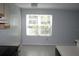 Bright kitchen area featuring large window and modern light fixture at 2593 Grassy Point Dr # 101, Lake Mary, FL 32746
