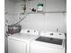 Laundry room featuring washer, dryer, water heater and shelving at 2593 Grassy Point Dr # 101, Lake Mary, FL 32746