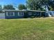Well-kept single-story home featuring a green lawn and lush landscaping at 312 Verbena Dr, Orlando, FL 32807