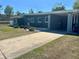 Exterior view of home featuring a long driveway and covered carport at 312 Verbena Dr, Orlando, FL 32807