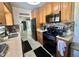 Well-equipped kitchen with wood cabinets, modern appliances, and stylish backsplash at 312 Verbena Dr, Orlando, FL 32807