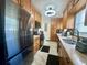Galley kitchen with wood cabinets, stainless steel appliances, and modern countertops at 312 Verbena Dr, Orlando, FL 32807