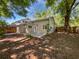 Backyard featuring lush greenery, a patio, and mature trees at 341 Kirkcaldy Dr, Winter Springs, FL 32708