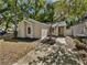 Inviting front exterior view of this charming home with a well-maintained yard and mature trees at 341 Kirkcaldy Dr, Winter Springs, FL 32708
