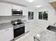 Modern kitchen featuring stainless steel appliances, granite countertops, and a tile backsplash at 341 Kirkcaldy Dr, Winter Springs, FL 32708