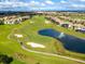 Breathtaking aerial view of the community with a golf course and a lake at 428 Ocean Course Ave, Davenport, FL 33896