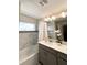 Bathroom featuring shower/tub combination, quartz countertops and modern lighting at 428 Ocean Course Ave, Davenport, FL 33896