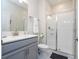Stylish bathroom with glass-enclosed shower, modern vanity, and neutral color palette at 428 Ocean Course Ave, Davenport, FL 33896