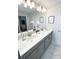 Bathroom featuring double sinks, quartz countertops, and modern lighting at 428 Ocean Course Ave, Davenport, FL 33896