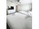 Comfortable bedroom featuring two beds, white linens, and a dresser with a TV at 428 Ocean Course Ave, Davenport, FL 33896