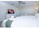 Bright bedroom features two twin beds, white dresser, and ceiling fan at 428 Ocean Course Ave, Davenport, FL 33896