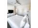 Cozy bedroom offering a ceiling fan, dresser with TV, and neutral decor throughout at 428 Ocean Course Ave, Davenport, FL 33896
