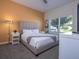 Cozy bedroom featuring a queen-sized bed, and large window with natural light at 428 Ocean Course Ave, Davenport, FL 33896