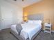 Bright bedroom with a queen-sized bed and a stylish bedside table at 428 Ocean Course Ave, Davenport, FL 33896