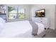 Bright bedroom featuring a white dresser, window view, and modern decor, offering a comfortable and inviting space at 428 Ocean Course Ave, Davenport, FL 33896