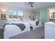 Bright bedroom with two twin beds, large window, ceiling fan and ensuite bath provides comfortable accommodations at 428 Ocean Course Ave, Davenport, FL 33896