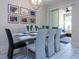 Bright dining room featuring a modern chandelier, gallery wall, and view of the cozy living area at 428 Ocean Course Ave, Davenport, FL 33896