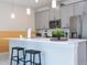 Kitchen island with pendant lighting, bar seating, and modern appliances, perfect for cooking and entertaining guests at 428 Ocean Course Ave, Davenport, FL 33896