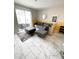Open concept living area featuring slider access to outdoor patio and grey L sofa at 428 Ocean Course Ave, Davenport, FL 33896