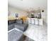 Open concept living area featuring kitchen island, grey L sofa, and modern decor at 428 Ocean Course Ave, Davenport, FL 33896