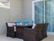Cozy outdoor patio with cushioned wicker furniture and table setting for relaxed dining at 428 Ocean Course Ave, Davenport, FL 33896