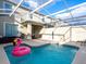 Private pool with a flamingo float and outdoor seating area at 428 Ocean Course Ave, Davenport, FL 33896