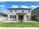 Spacious backyard with a well-maintained lawn and a covered patio perfect for outdoor relaxation and entertainment at 5144 Ravena E Ave, St Cloud, FL 34771