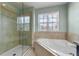 This bathroom boasts both a glass shower and a tub below the window at 5144 Ravena E Ave, St Cloud, FL 34771