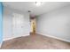 This bedroom features neutral carpet, a closet, and an entrance to a hallway at 5144 Ravena E Ave, St Cloud, FL 34771