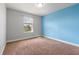 This bedroom offers neutral carpet, bright natural light and a feature wall at 5144 Ravena E Ave, St Cloud, FL 34771