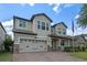 Inviting home with a well-manicured lawn, a brick driveway, and a charming two-car garage at 5144 Ravena E Ave, St Cloud, FL 34771