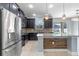 Well-lit kitchen features a granite countertop island, stainless appliances, and dark cabinetry at 5144 Ravena E Ave, St Cloud, FL 34771