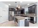 Well-lit kitchen boasts stainless steel appliances, granite counters and dark wood cabinetry at 5144 Ravena E Ave, St Cloud, FL 34771