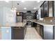 Open kitchen features stainless appliances, granite countertops, dark wood cabinets, and island at 5144 Ravena E Ave, St Cloud, FL 34771