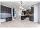 Open kitchen has stainless steel appliances, granite counters, an island, and dark cabinets at 5144 Ravena E Ave, St Cloud, FL 34771