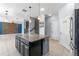 Stylish kitchen featuring a dark island with granite countertop, stainless steel appliances, and modern pendant lighting at 5144 Ravena E Ave, St Cloud, FL 34771