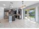 Modern kitchen boasting dark cabinets, stainless steel appliances, an island, and a seamless connection to the backyard at 5144 Ravena E Ave, St Cloud, FL 34771
