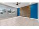 Bright living room boasts tile floors, natural light, accent wall, and a ceiling fan at 5144 Ravena E Ave, St Cloud, FL 34771