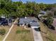 Aerial view of the home with green lawn, long driveway, and mature trees at 515 Columbus Ave, Orange City, FL 32763