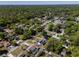 Scenic aerial view of a neighborhood surrounded by lush green trees and well-maintained homes at 515 Columbus Ave, Orange City, FL 32763