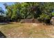 A spacious backyard featuring a wooden fence, a pool enclosure and ample room for outdoor activities at 515 Columbus Ave, Orange City, FL 32763
