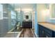 Bright bathroom with glass enclosed shower, dark vanity, and luxury vinyl plank flooring at 515 Columbus Ave, Orange City, FL 32763