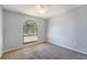Neutral bedroom with double hung window and neutral carpet at 515 Columbus Ave, Orange City, FL 32763