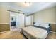 Bedroom features a white sliding barn door to the ensuite bathroom and neutral carpet at 515 Columbus Ave, Orange City, FL 32763