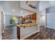 Open kitchen design with wood floors, breakfast bar, and stainless-steel appliances at 515 Columbus Ave, Orange City, FL 32763