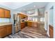 Well-lit kitchen with stainless steel appliances, wood cabinets, and wood floors at 515 Columbus Ave, Orange City, FL 32763