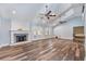 Spacious living room with fireplace, vaulted ceilings, wood floors, and double ceiling fans at 515 Columbus Ave, Orange City, FL 32763